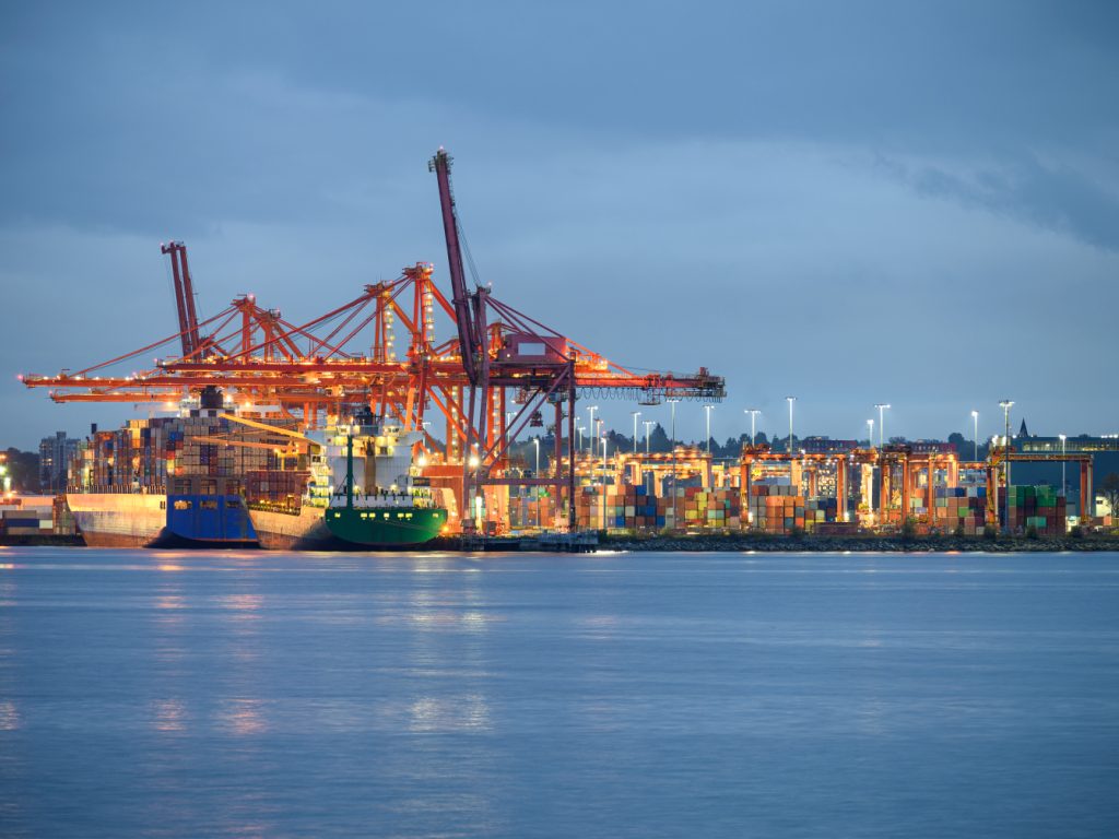 Container vessel loaded with stacked shipping containers on an international trade route