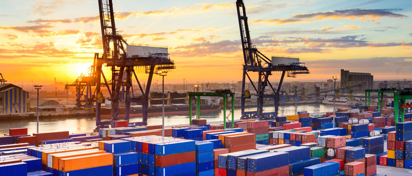 Industrial port at first light with cranes and cargo handling equipment